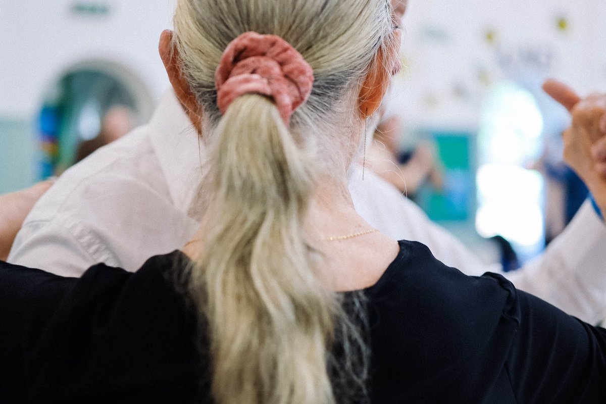 Dettaglio dell'abbraccio di una coppia di tango in milonga